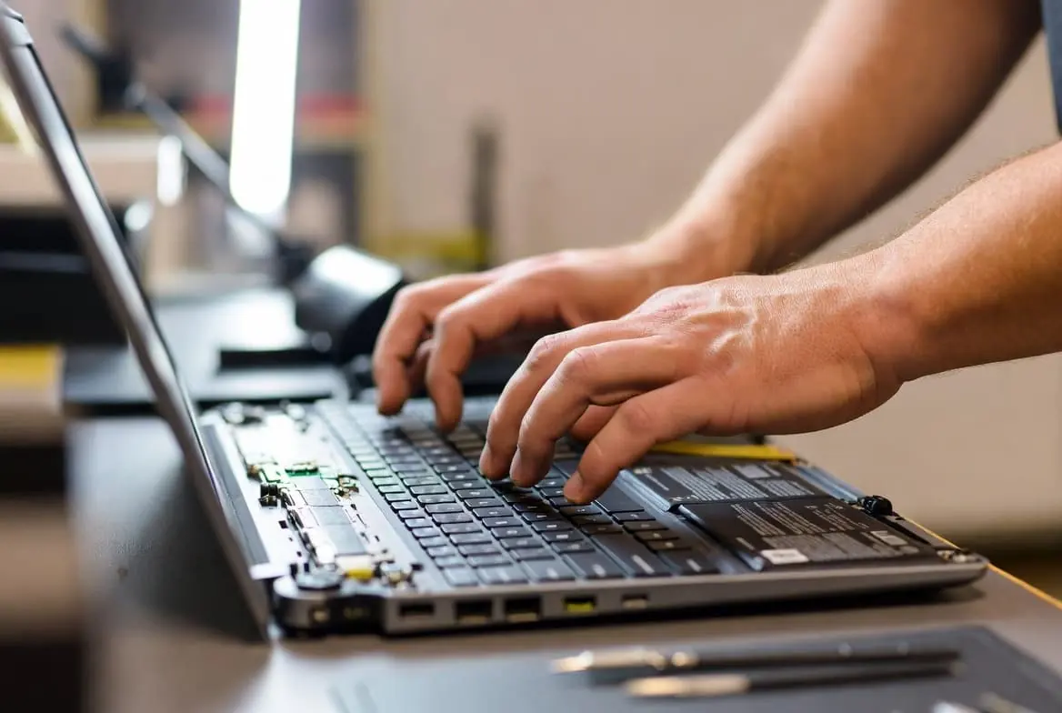 Certified NoBull IT Solutions technician repairing a laptop computer at the Johnstown repair shop